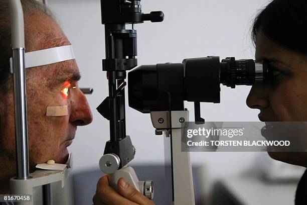 By Lawrence Barlett The Royal Flying Doctor Service's Dr Shweta Kaushik checks the cataracts of opal expert Len Cram in Lightning Ridge in the...