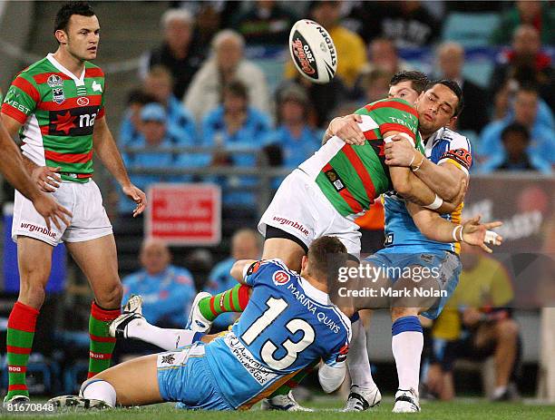 John Sutton of the Rabbitohs offloads during the round 15 NRL match between the South Sydney Rabbitohs and the Gold Coast Titans at ANZ Stadium on...