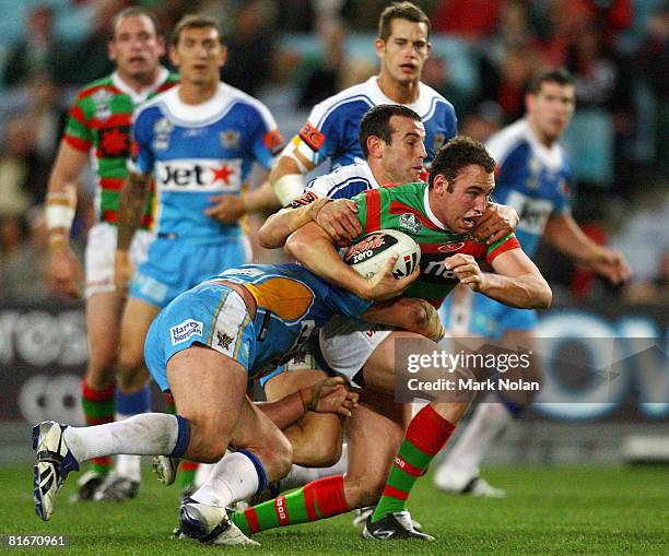 Ben Lowe of the Rabbitohs is tackled during the round 15 NRL match between the South Sydney Rabbitohs and the Gold Coast Titans at ANZ Stadium on...