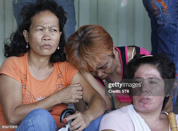 Relatives of passengers of the ill-fated MV Princess of the Stars wait for news of their missing kin at the office of Sulpicio Lines in Manila on...