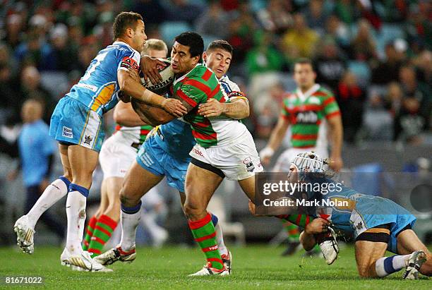 David Fa'Alogo of the Rabbitohs is tackled during the round 15 NRL match between the South Sydney Rabbitohs and the Gold Coast Titans at ANZ Stadium...