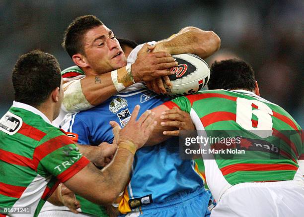 Mark Minichiello of the Titans is tackled during the round 15 NRL match between the South Sydney Rabbitohs and the Gold Coast Titans at ANZ Stadium...