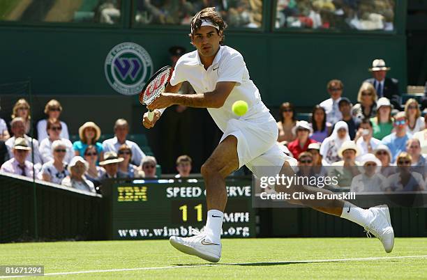 Roger Federer of Switzerland plays a forehand during the men's singles round one match against Dominik Hrbaty of Slovakia on day one of the Wimbledon...