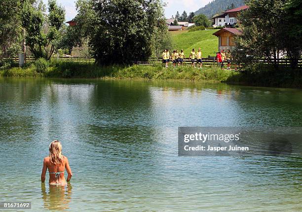 Swimmer watches the Spanish national team walking during a light training session the day after their quarter-final match at the Kampl training...