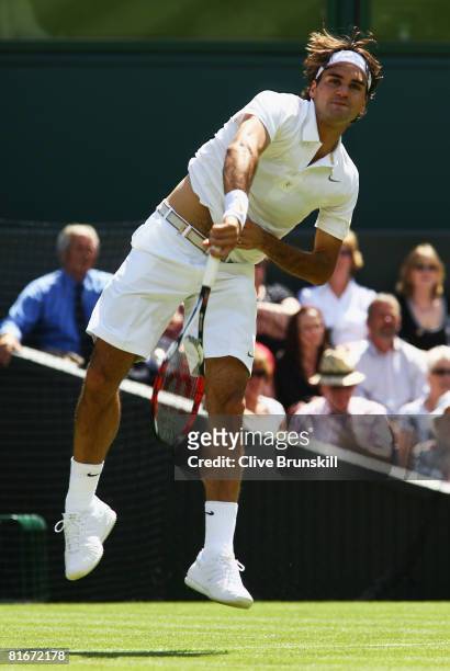 Roger Federer of Switzerland serves during the men's singles round one match against Dominik Hrbaty of Slovakia on day one of the Wimbledon Lawn...