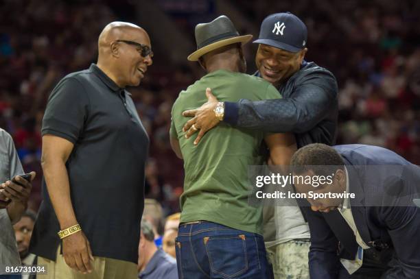 Rapper LL Cool J greets boxer Bernard Hopkins during a BIG3 Basketball league game on July 16, 2017 at Wells Fargo Center in Philadelphia, PA