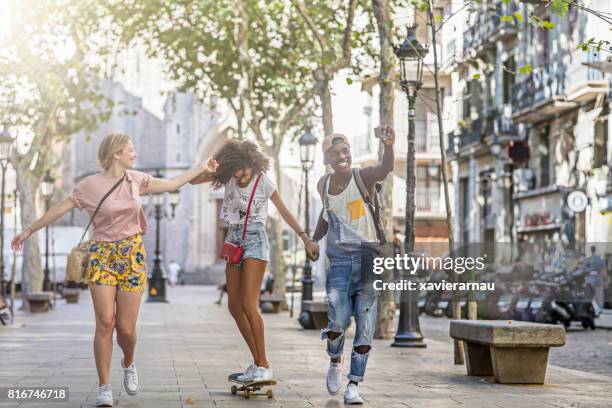 friends longboarding in the city. - longboard surfing stock pictures, royalty-free photos & images