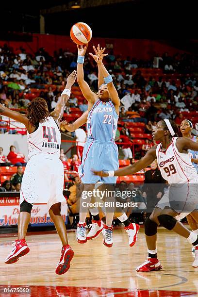 Betty Lennox of the Atlanta Dream shoots a jumper between Shannon Johnson and Hamch?tou Ma?ga-Ba of the Houston Comets during the WNBA game on June...