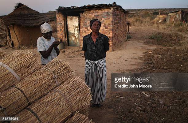 Grandmothers who's children died of AIDS stand in front of their homes in the countryside June 23, 2008 outside of Bulawayo, Zimbabwe. The nation...