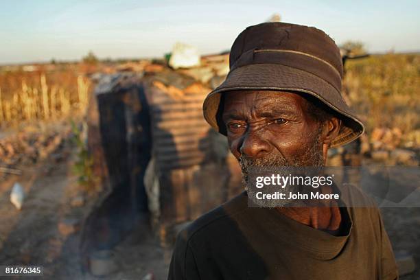 Webber Mumba stands outside his home June 23, 2008 outside of Bulawayo, Zimbabwe. With Zimbabwe's annual inflation rate at more than 150,000 percent,...