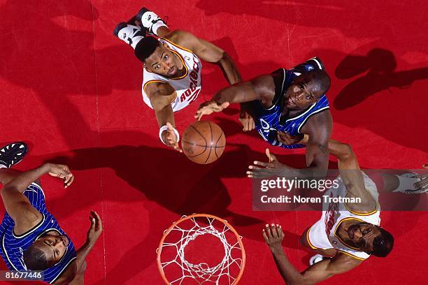 Robert Horry and Charles Jones of the Houston Rockets battle for a rebound against Shaquille O'Neal of the Orlando Magic in Game Four of the 1995 NBA...