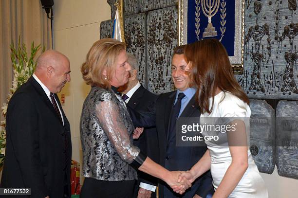 In this handout image provided by the Israeli Goverment Press Office , Israel's Foreign Minister Zipi Livni shakes hands with Carla Bruni-Sarkozy ,...
