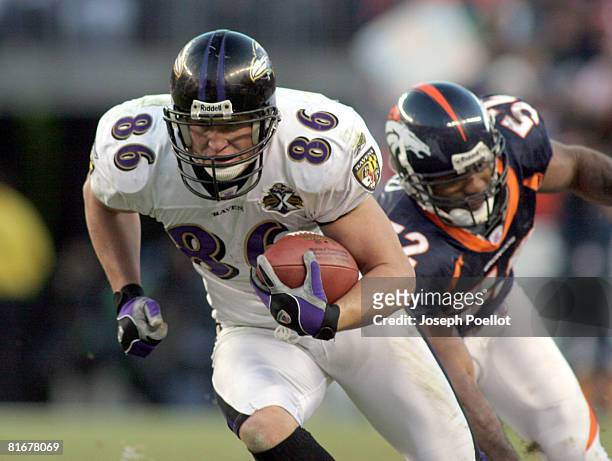 Baltimore Ravens Todd Heap slips past Denver Broncos Ian Gold for a gain in game during the Baltimore Ravens vs Denver Broncos game on December 11,...