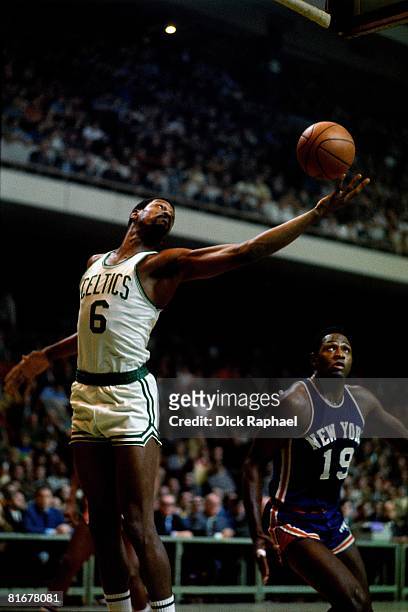 Bill Russell of the Boston Celtics grabs the rebound against Willis Reed of the New York Knicks circa 1970's at the Boston Garden in Boston,...