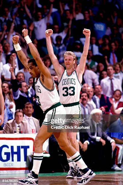 Larry Bird and Dennis Johnson of the Boston Celtics celebrate during a game circa 1984-1990 at the Boston Garden in Boston, Massachusetts. NOTE TO...