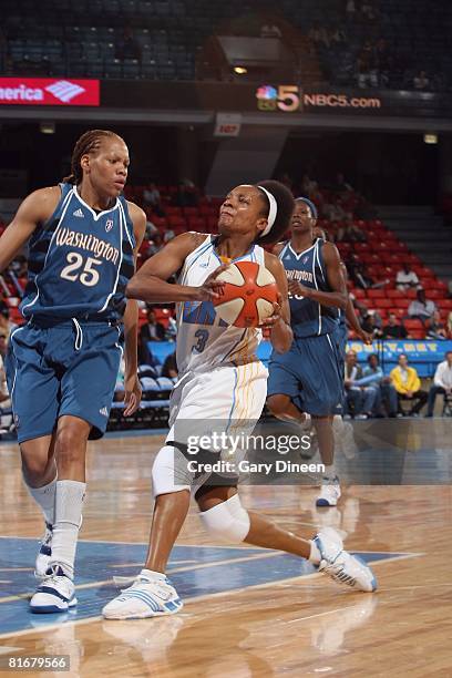 Dominique Canty of the Chicago Sky moves the ball against Monique Currie of the Washington Mystics during the game on June 13, 2008 at the UIC...