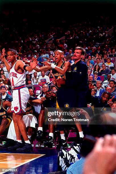 Reggie Miller of the Indiana Pacers looks for a foul call against Hubert Davis of the New York Knicks in Game One of the Eastern Conference...