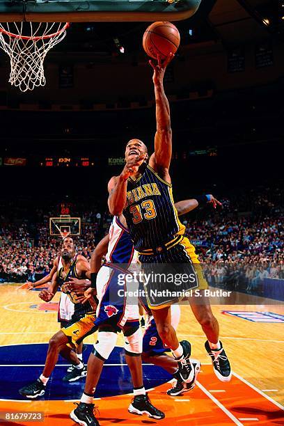 Antonio Davis of the Indiana Pacers shoots a layup against Patrick Ewing of the New York Knicks in Game Four of the Eastern Conference Semifinals...