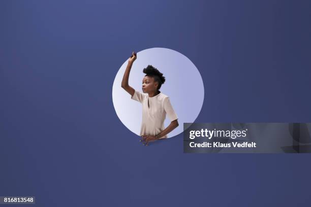 woman placed inside round opening in coloured wall - change appearance stock pictures, royalty-free photos & images