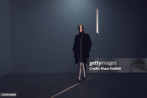 woman walking in thin light stripe, in studio with concrete floor - woman tightrope stock pictures, royalty-free photos & images