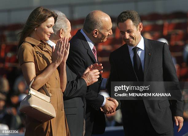 French First Lady Carla Bruni-Sarkozy , Israeli President Shimon Peres stand as French President Nicolas Sarkozy shakes hands with Israeli Prime...