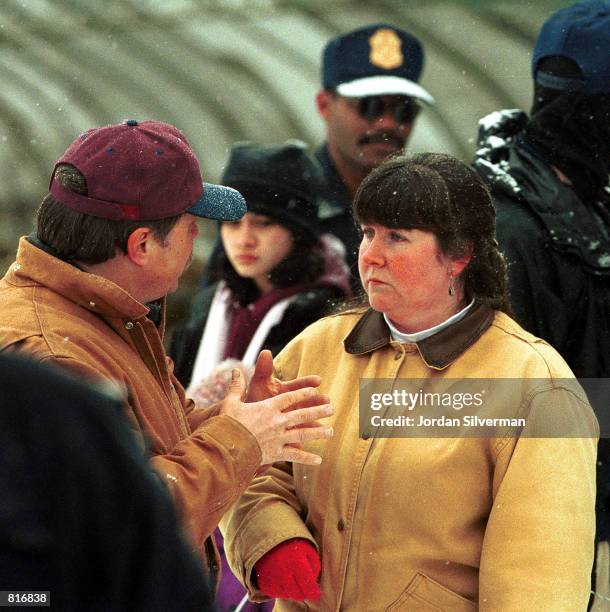Linda Fallaice holds a lamb before it is taken by a U.S. Department of Agriculture agent at her farm March 23, 2001 in East Warren, Vermont. The...