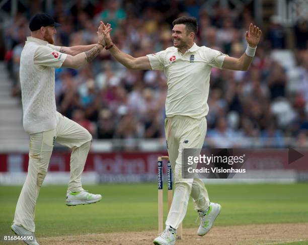 England's Jimmy Anderson celebrates with team mate Ben Stokes after taking the wicket of Quinton de Kock of South Africa during the third day of the...