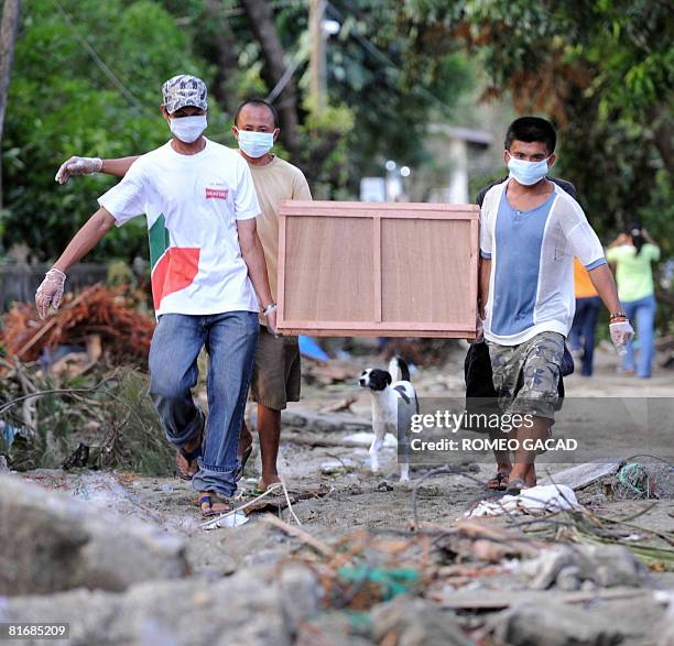 Residents of the typhoon hit Sibuyan island in central Philippines carry an improvised coffin bearing a body of a passenger from the sunken ferry MV...