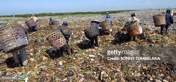 Scavengers collect salable items from a garbage dump in Denpasar on Bali island on June 24, 2008. More than 1,000 people from 170 countries,...