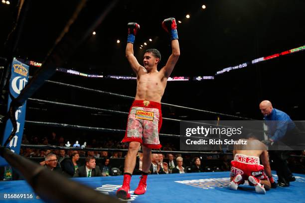 Omar Figueroa Jr., raises his arms after knocking Robert Guerrero down to the canvas for the third time during the second round of their Welterweight...