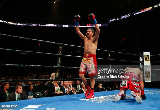 Omar Figueroa Jr., raises his arms after knocking Robert Guerrero down to the canvas for the third time during the second round of their Welterweight...