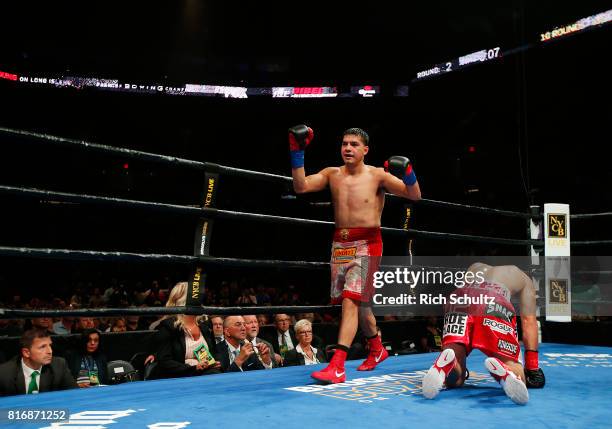 Omar Figueroa Jr., raises his arms after knocking Robert Guerrero down to the canvas for the third time during the second round of their Welterweight...