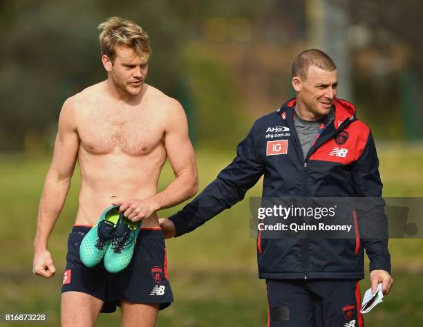 Jack Watts of the Demons speaks to head coach Simon Goodwin during a Melbourne Demons AFL training session at Gosch's Paddock on July 18, 2017 in...