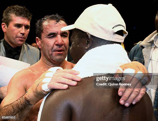 Jeff Fenech and Azumah Nelson hug after their welterweight fight at the Vodafone Arena on June 24, 2008 in Melbourne, Australia.