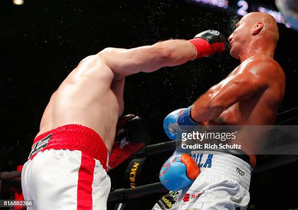 Adam Kownack, left, of Poland lands a right punch to the head of Artur Szpilka of Poland in their Heavyweight fight at Nassau Veterans Memorial...