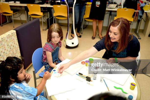 Alyson Hannigan and daughter, Satyana Denisof , interact with kids with Starlight Children's Foundation at LAC+USC Medical Center on July 17, 2017 in...