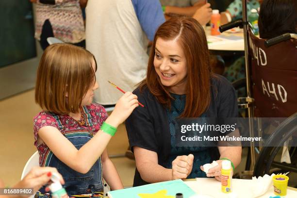 Alyson Hannigan and daughter, Satyana Denisof , interact with kids with Starlight Children's Foundation at LAC+USC Medical Center on July 17, 2017 in...