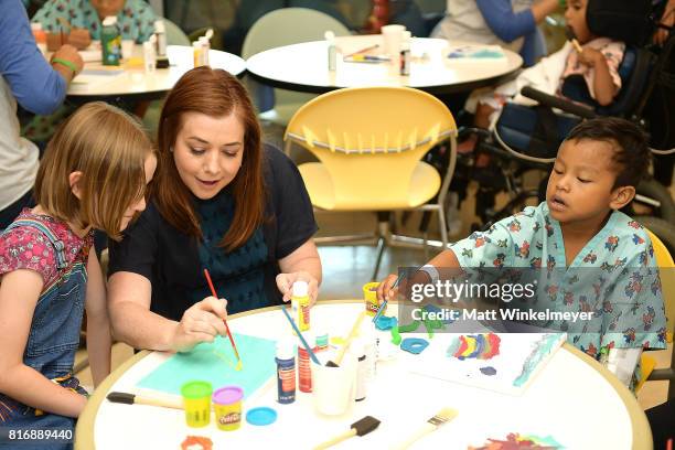 Alyson Hannigan and daughter, Satyana Denisof , interact with kids with Starlight Children's Foundation at LAC+USC Medical Center on July 17, 2017 in...