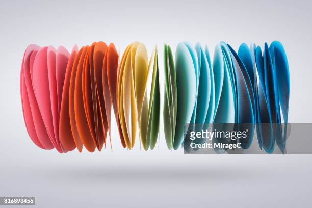 colorful paper pile levitation in mid-air - group c foto e immagini stock