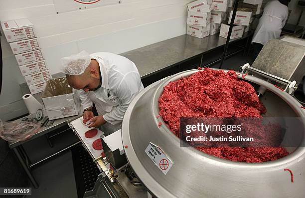 Carlos Vasquez stacks ground beef patties as they come off a conveyor belt at a meat packing and distribution facility June 24, 2008 in San...