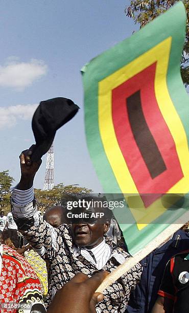 Zimbabwe's President Robert Mugabe greets supporters at a rally in Banket, 70 kms from Harare on June 24, 2008. President Mugabe said the elections...