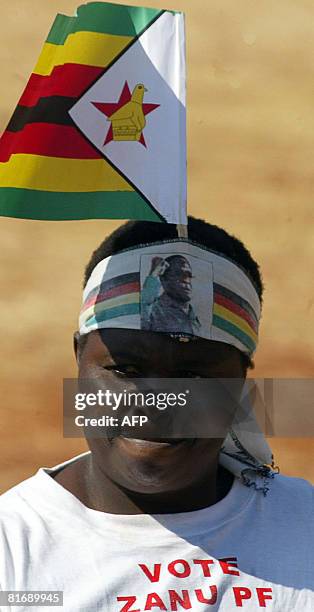 Zimbabwean suppoter of President Robert Mugabe attends a rally in Banket, 70 km from Harare on June 24, 2008. Zimbabwe's run-off election will go...