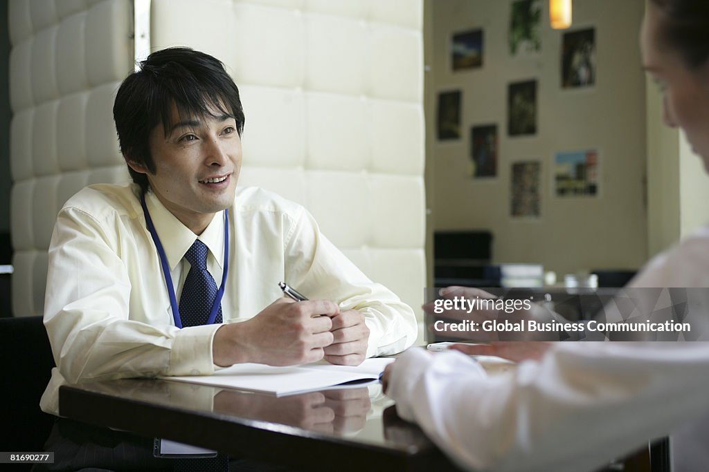 Male executive having discussion with colleague