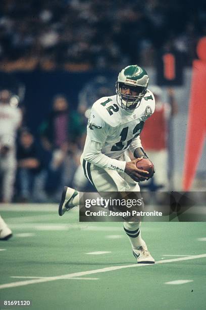 Quarterback Randall Cunningham of the Philadelphia Eagles rolls out to pass against the New Orleans Saints at the Superdome in the 1992 NFC Wild Card...