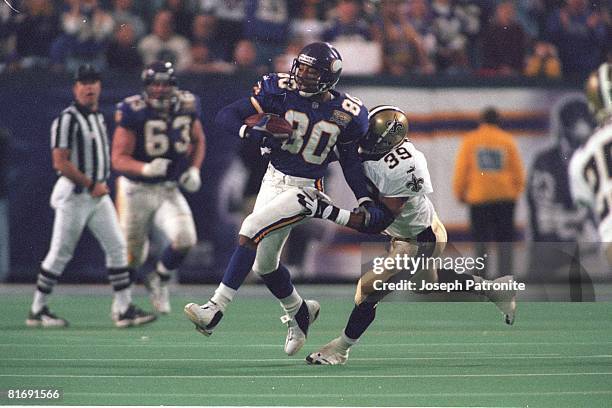 Wide receiver Cris Carter of the Minnesota Vikings runs upfield after making a catch a pass against the sideline against the New Orleans Saints in...