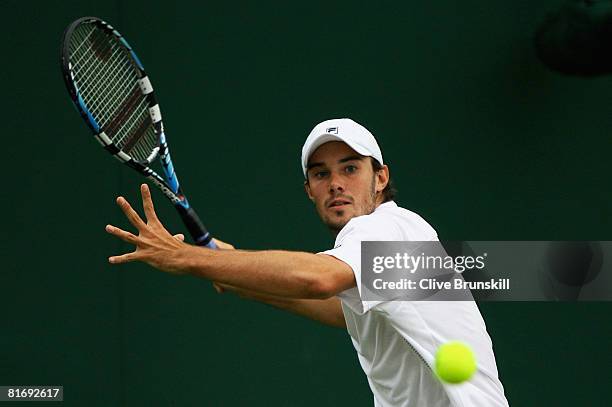 Chris Eaton of United Kingdom plays a forehand during the men's singles round one match against Boris Pashanski of Serbia on day two of the Wimbledon...