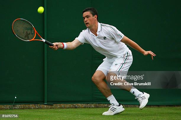 Jamie Baker of United Kingdom plays a forehand during the men's singles round one match against Stefano Galvani of Italy on day two of the Wimbledon...