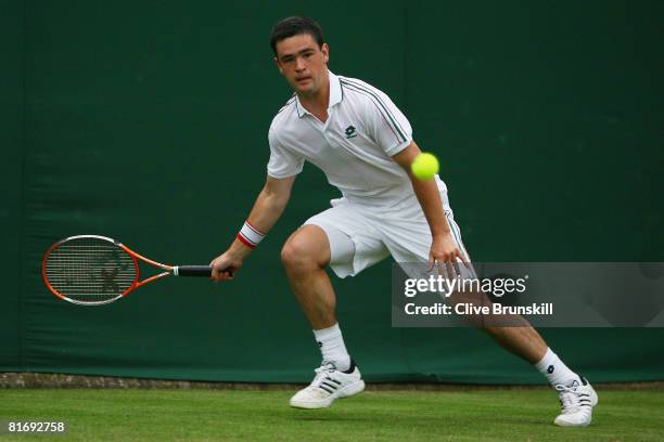 Jamie Baker of United Kingdom plays a forehand during the men's singles round one match against Stefano Galvani of Italy on day two of the Wimbledon...