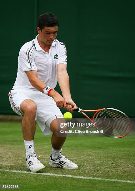 Jamie Baker of United Kingdom plays a backhand during the men's singles round one match against Stefano Galvani of Italy on day two of the Wimbledon...