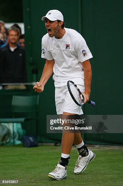 Chris Eaton of United Kingdom celebrates winning the men's singles round one match against Boris Pashanski of Serbia on day two of the Wimbledon Lawn...